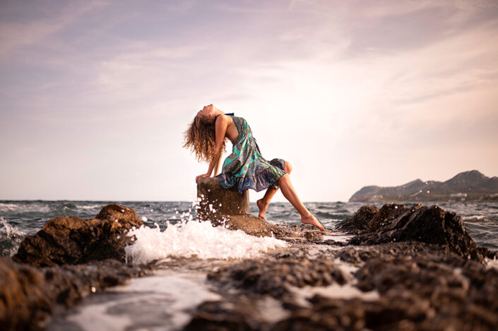 Girl on rock in the sea