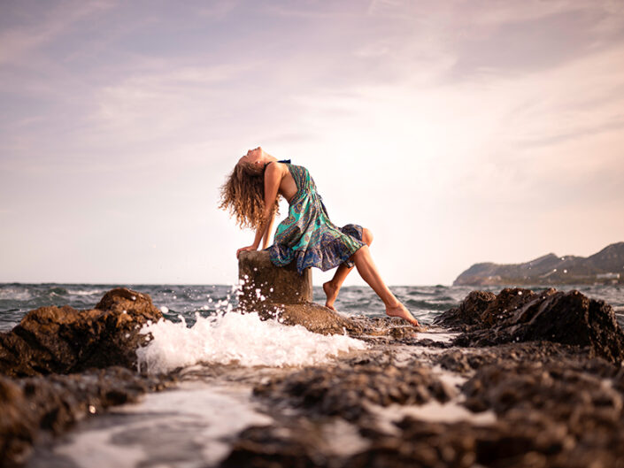 Girl on rock in the sea